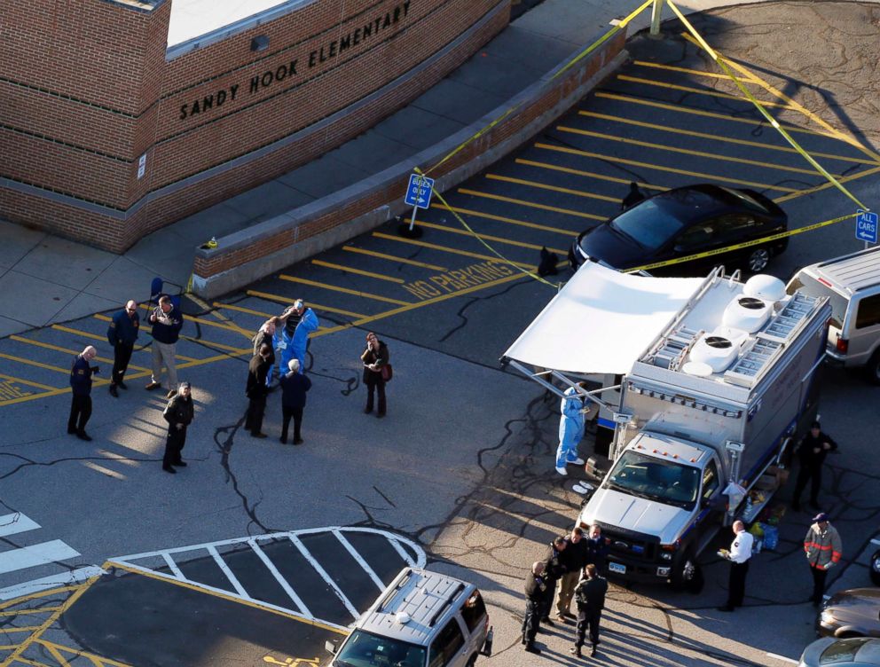  Officials are on the scene outside of Sandy Hook Elementary School in Newtown, Conn., where authorities say a gunman opened fire inside an elementary school in a shooting that left 27 people dead, including 20 children, Dec. 14, 2012.					