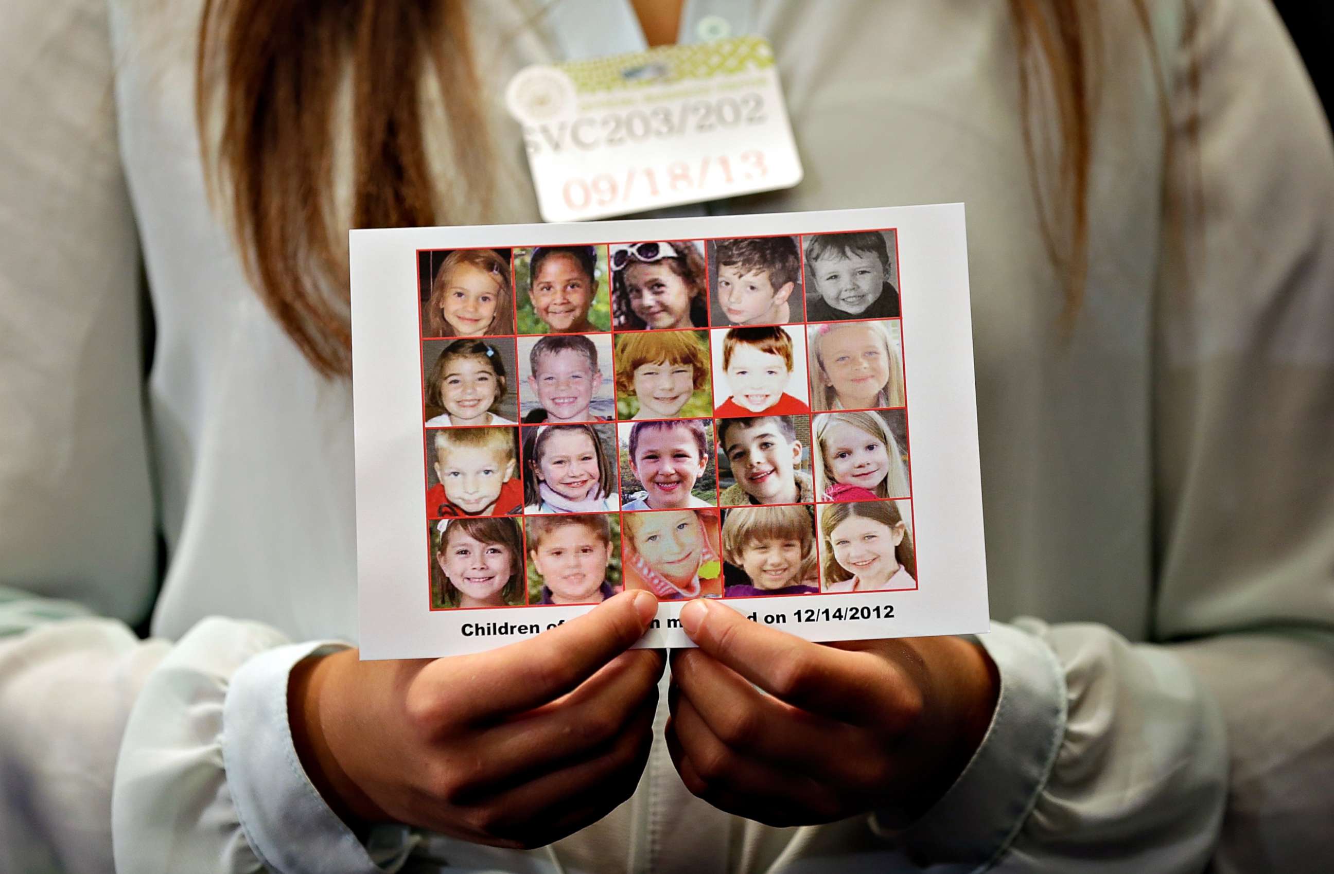 PHOTO: Kyra Murray holds a photo showing victims of the shooting at Sandy Hook Elementary School during a press conference at the U.S. Capitol calling for gun reform legislation, Sept. 18, 2013, in Washington, D.C. 