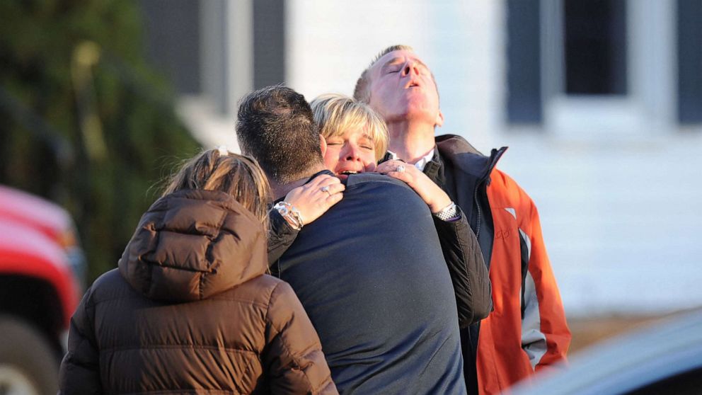 PHOTO: People embrace in the aftermath of the shooting at Sandy Hook Elementary School in Newtown, Conn., Dec. 14, 2012.