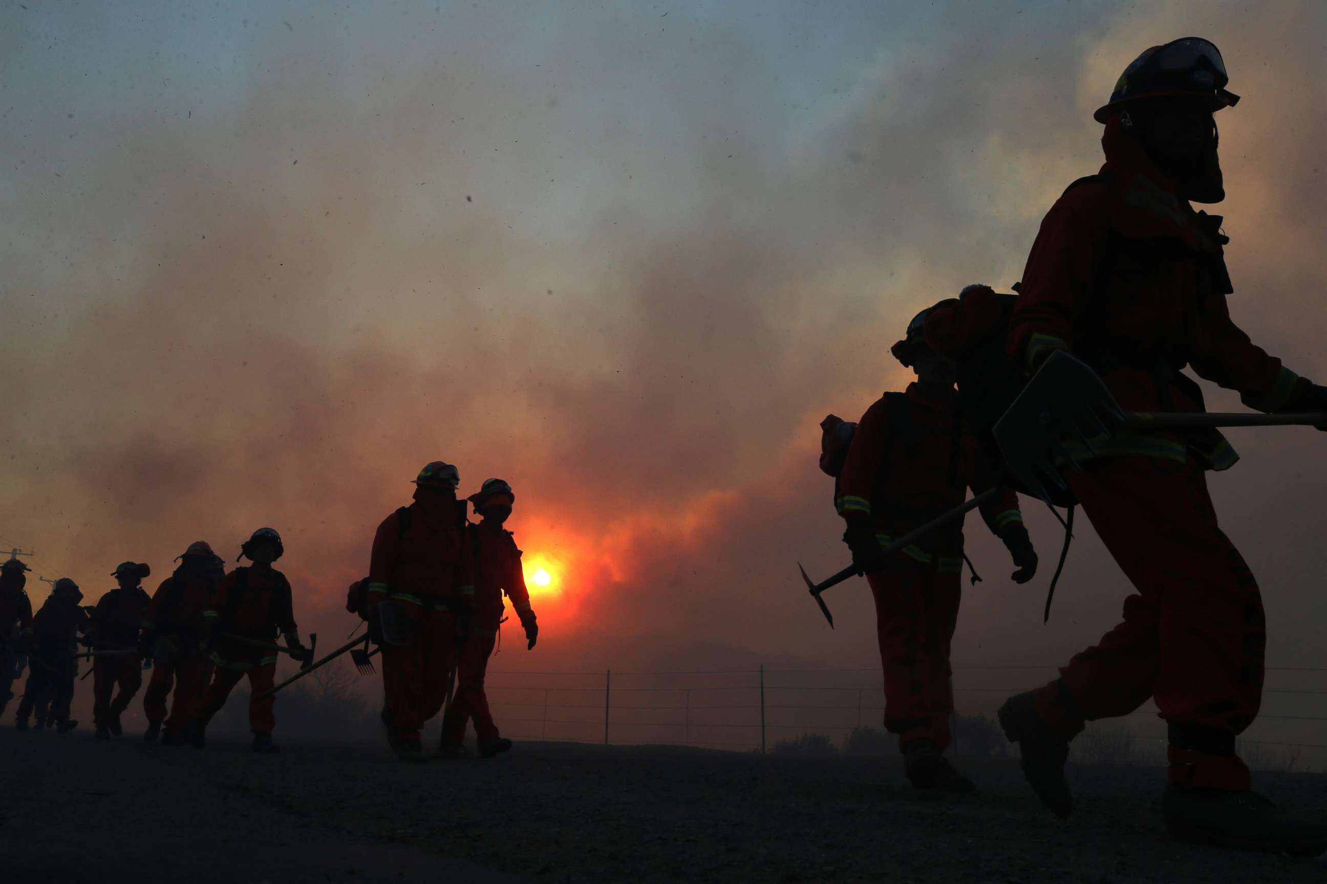 PHOTO: Inmate firefighters work as the Bond Fire burns shortly after sunrise in the Silverado Canyon area of Orange County, California, Dec. 3, 2020.