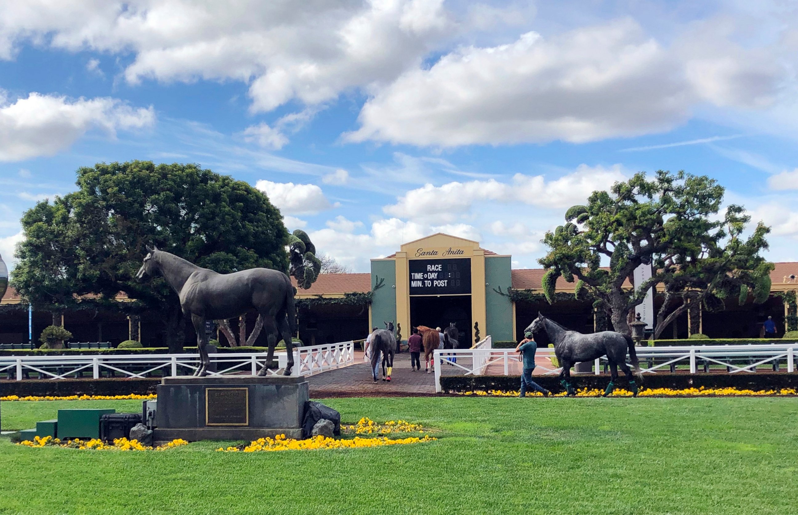 PHOTO: Horses are led to paddocks past the Seabiscuit statue during workouts at Santa Anita Park, in Arcadia, Calif., Thursday, March 28, 2019.