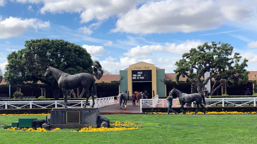 PHOTO: Horses are led to paddocks past the Seabiscuit statue during workouts at Santa Anita Park, as members of the California Horse Racing Board weigh new safety rules in the wake of 22 horse deaths at the track in Arcadia, Calif., March 28, 2019.
