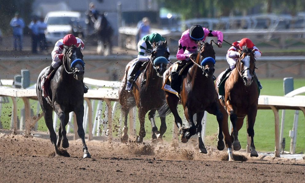 PHOTO: Roadster, right, with jockey Mike Smith, heads to the finish and the win in the Santa Anita Derby horse race at Santa Anita in Arcadia, Calif., April 6, 2019.