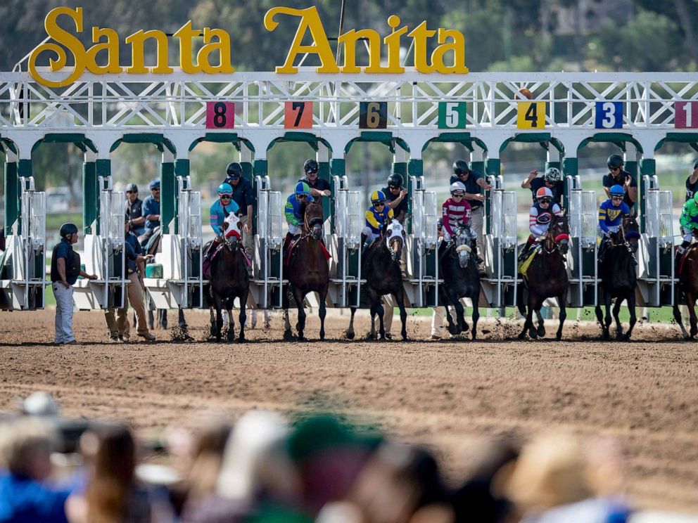 PHOTO: The field for the 6th race breaks from the starting gate as fans look on at Santa Anita Park, March 29, 2019, in Arcadia, Calif.