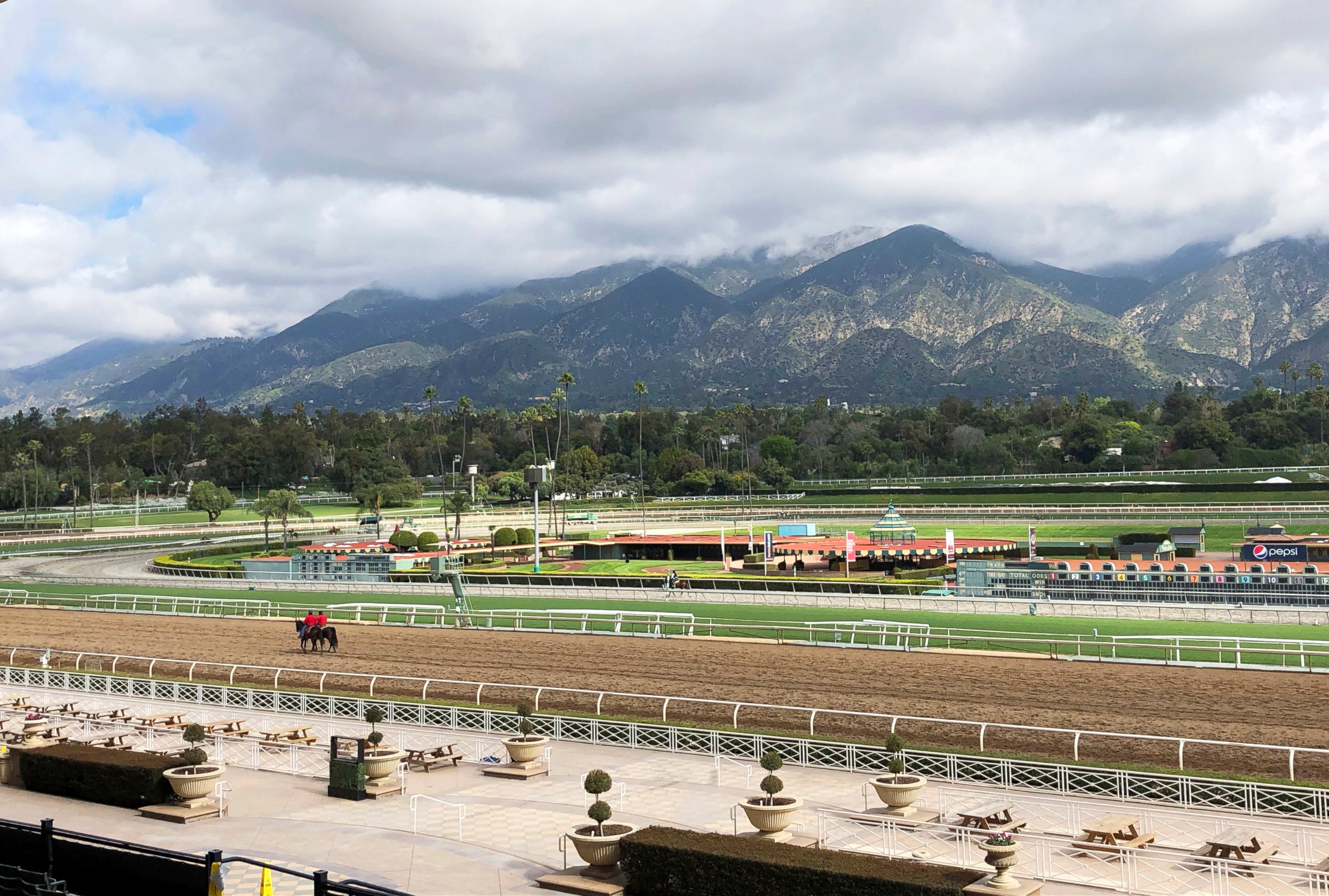 PHOTO: A few horses and riders are seen on the track while members of the California Horse Racing Board weigh new safety and medication rules in the wake of 22 horse deaths at Santa Anita Park, during a meeting at the track in Arcadia, Calif.