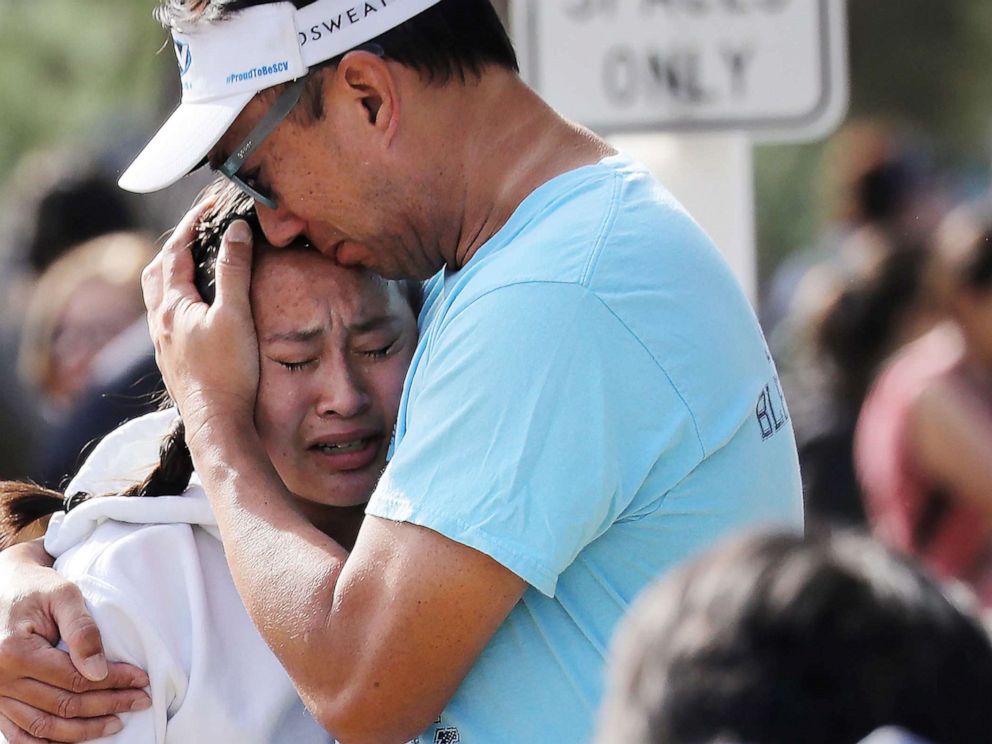 PHOTO: A father hugs his daughter after being reunited at a park near Saugus High School after a shooting on Nov. 14, 2019 in Santa Clarita, Calif.