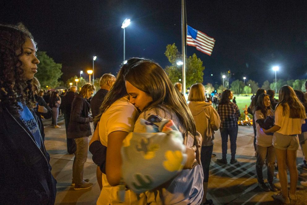 PHOTO: Mourners hug each other at a vigil held for shooting victims, Nov. 17, 2019, in Santa Clarita, California.