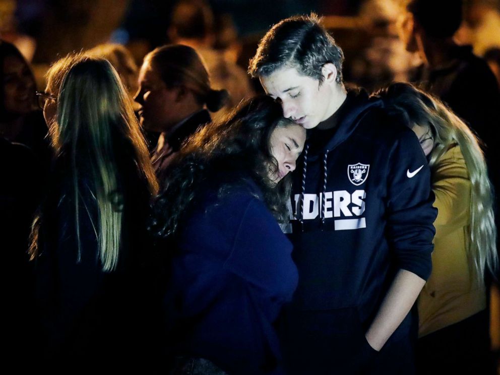 PHOTO: Hannah Schooping-Gutierrez, center, is comforted by her boyfriend Declan Sheridan, at right, a student at nearby Valencia High School during a vigil at Central Park in the aftermath of a shooting at Saugus Nov. 14, 2019, in Santa Clarita, Calif.