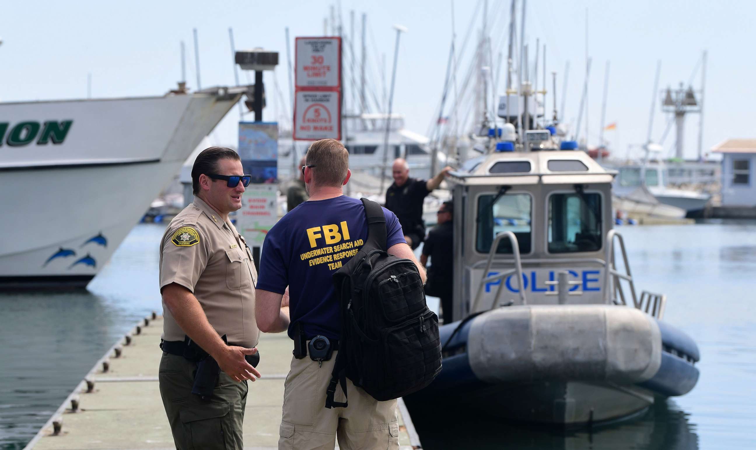 PHOTO: An officer from the FBI underwater search and evidence response team speaks with a California law enforcement officer near a Long Beach Police vessel in Santa Barbara, Calif., Sept. 3, 2019.