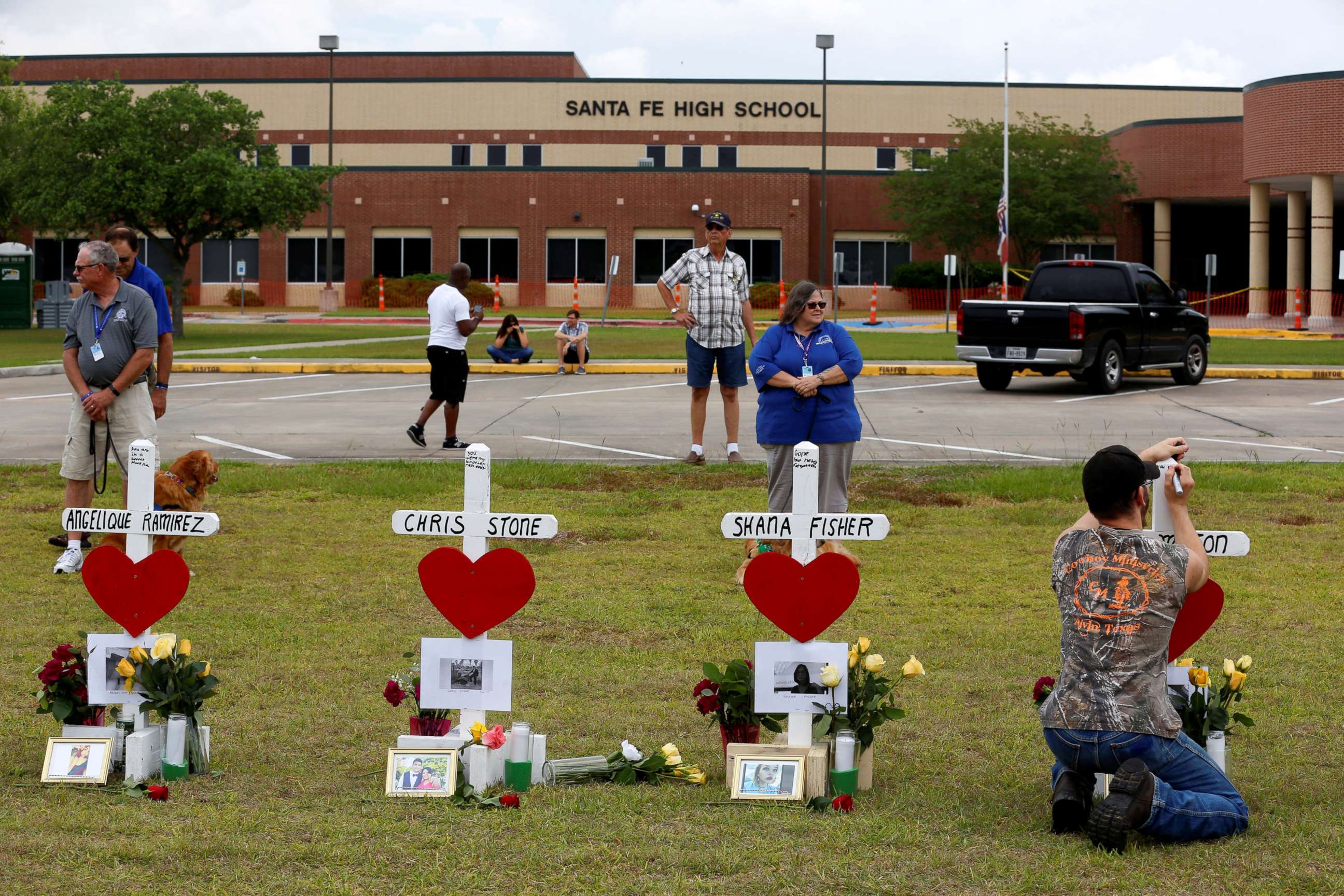 PHOTO: People gather at a makeshift memorial left in memory of the victims killed in a shooting at Santa Fe High School in Santa Fe, Texas, May 21, 2018.