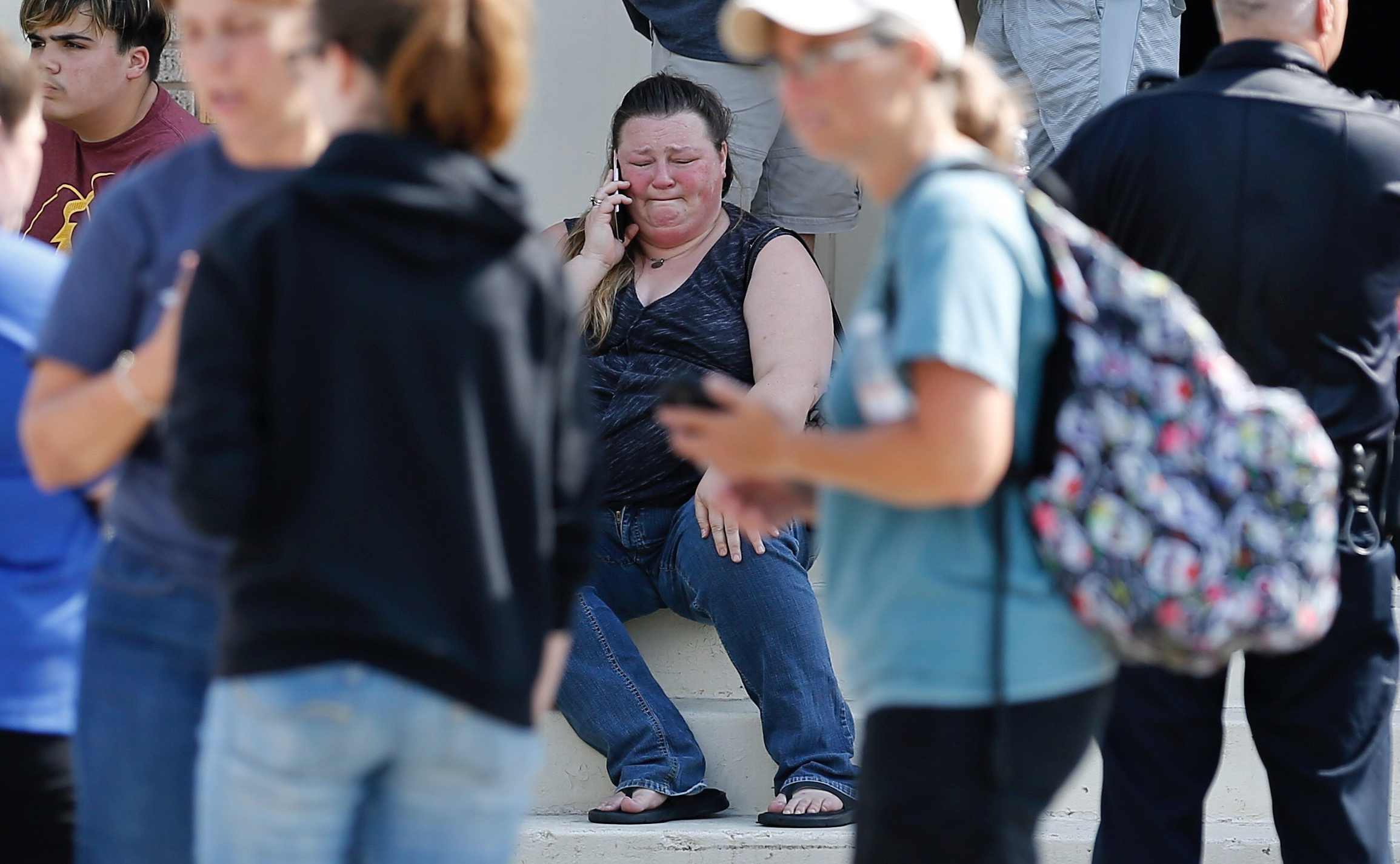 PHOTO: A woman reacts while making a phone call outside the Alamo Gym where parents wait to reunite with their children following a shooting at Santa Fe High School in Santa Fe, Texas, May 18, 2018.