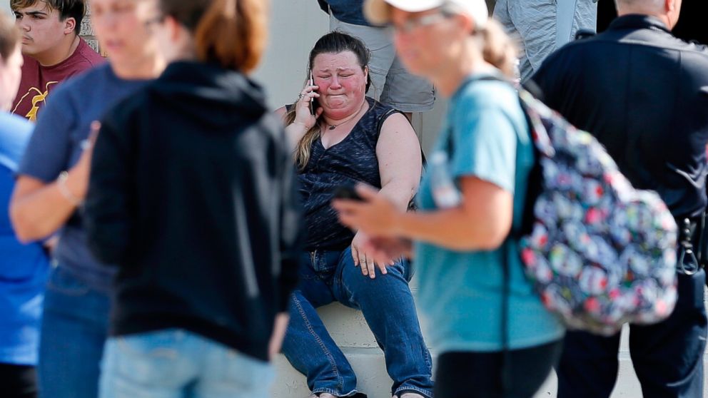 PHOTO: A woman reacts while making a phone call outside the Alamo Gym where parents wait to reunite with their children following a shooting at Santa Fe High School in Santa Fe, Texas, May 18, 2018.