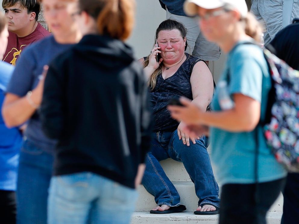 PHOTO: A woman reacts while making a phone call outside the Alamo Gym where parents wait to reunite with their children following a shooting at Santa Fe High School in Santa Fe, Texas, May 18, 2018.