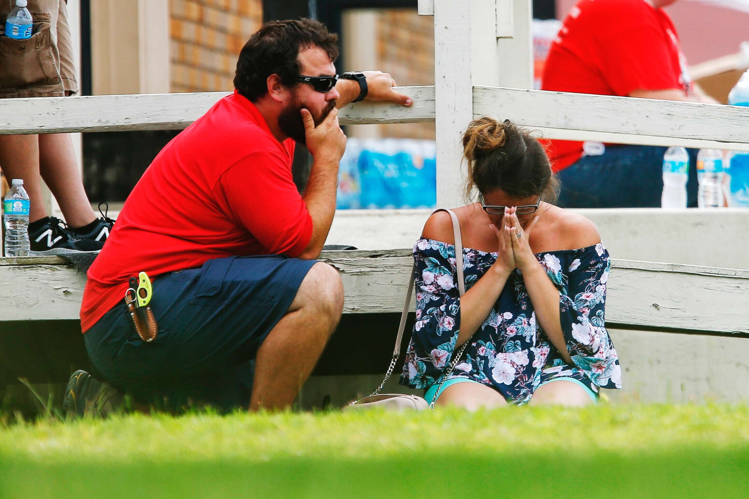 PHOTO: A woman prays in the grass outside the Alamo Gym where parents wait to reunite with their kids following a shooting at Santa Fe High School, May 18, 2018, in Santa Fe, Texas.