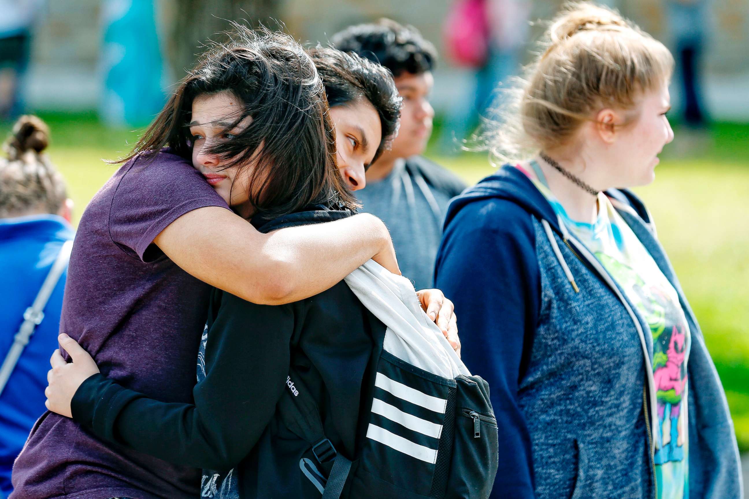 PHOTO: Santa Fe High School freshman Caitlyn Girouard, center, hugs her friend outside the Alamo Gym where students and parents wait to reunite following a shooting at Santa Fe High School, May 18, 2018, in Santa Fe, Texas.