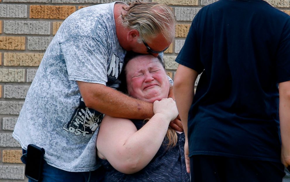 PHOTO: A man hugs a woman outside the Alamo Gym where parents wait to reunite with their children following a shooting at Santa Fe High School in Santa Fe, Texas, May 18, 2018.