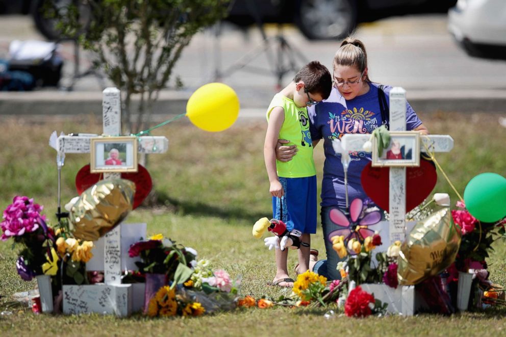 PHOTO: Mourners visit a memorial in front of Santa Fe High School on May 22, 2018, in Santa Fe, Texas.