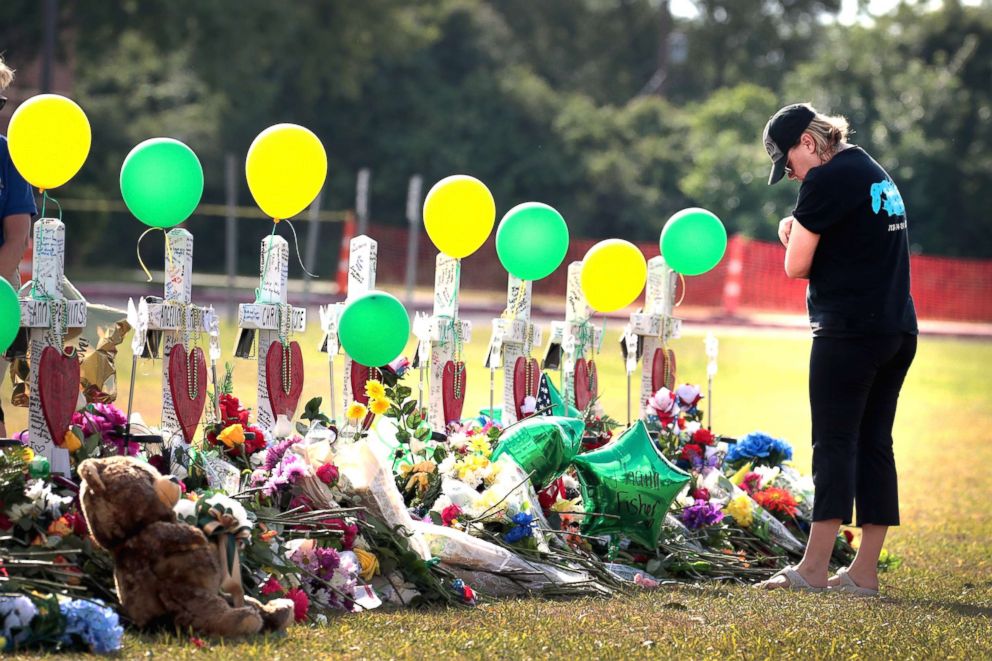 PHOTO: Mourners visit a memorial in front of Santa Fe High School on May 22, 2018, in Santa Fe, Texas.