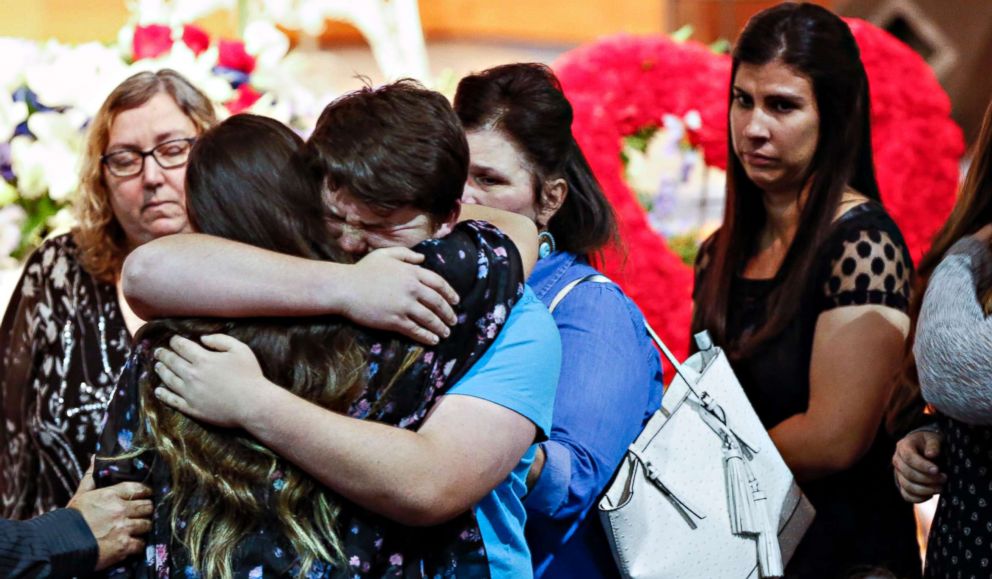 Mourners embrace the family of Christian Riley Garcia during his funeral at Crosby Church on May 25, 2018, in Houston. The 15-year-old student was one of 10 people killed on May 18, 2018, during a mass shooting at Santa Fe High School. 