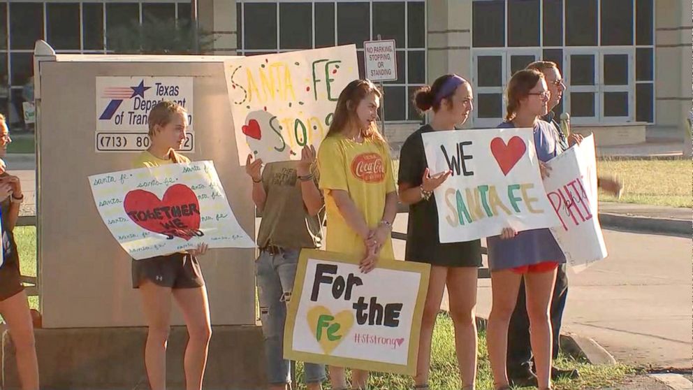PHOTO: Santa Fe High School students were greeted by community members holding signs of support as they returned to class, May 29, 2018.