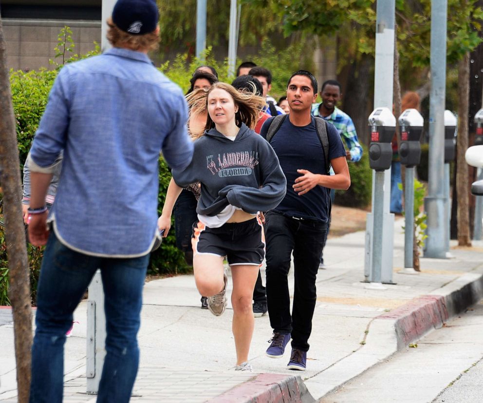 PHOTO:Students rush to safety after shots were fired near the Santa Monica College, June 7, 2013, in Santa Monica, Calif.