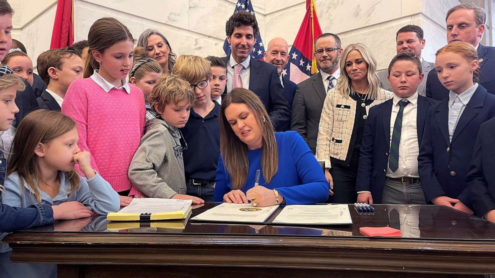 PHOTO: Arkansas Gov. Sarah Huckabee Sanders signs into law an education overhaul bill on March 8, 2023, at the state Capitol in Little Rock, Ark.