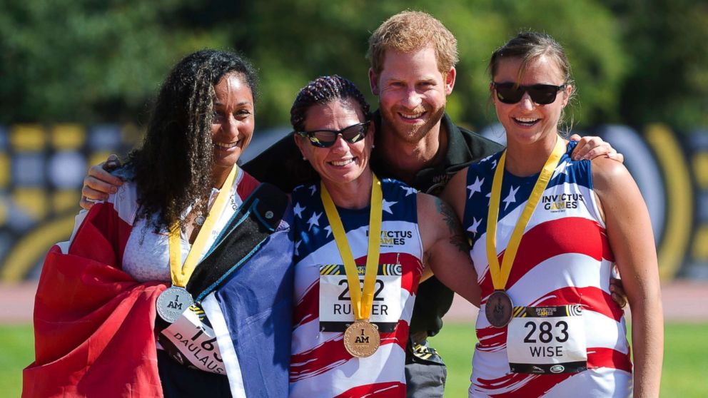 PHOTO: Prince Harry poses with women's 100-meter dash medallists, from the left, Sabrina Daulaus of France, silver, Sarah Rudder of the USA, gold, and Christy Wise of the USA, bronze, at the Invictus Games in Toronto, Sept. 24, 2017. 