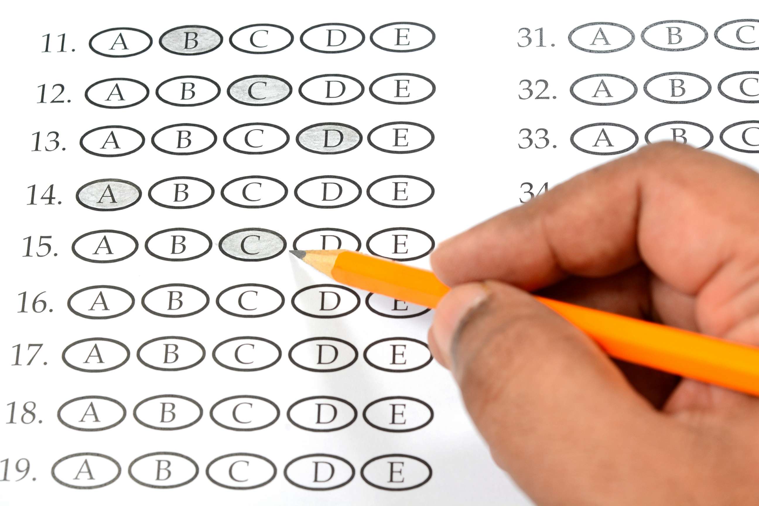 PHOTO: A student appears to be filling out a multiple choice exam paper with a pencil.
