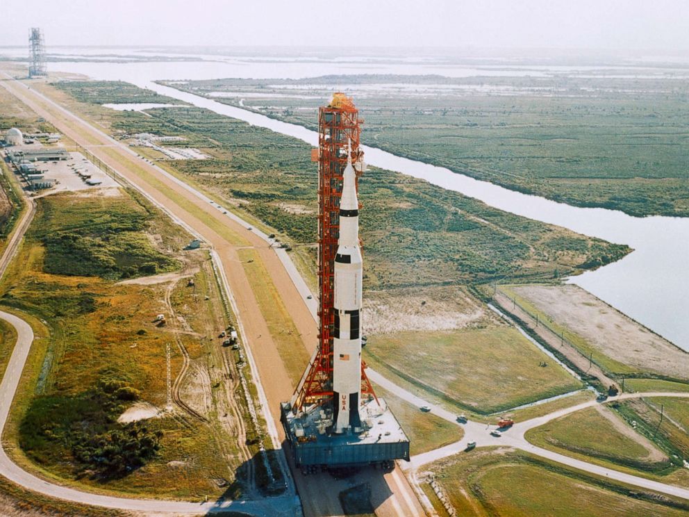 PHOTO: The Saturn V rocket with umbilical tower is moved on a crawler-transporter from the Kennedy Space Center's Vehicle Assembly Building to the launch complex in Florida in October 1968.