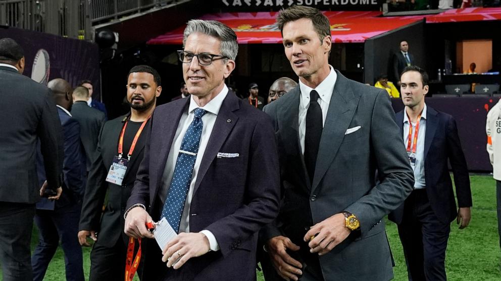 PHOTO: Tom Brady, right, and Kevin Burkhardt before Super Bowl LIX between the Philadelphia Eagles and the Kansas City Chiefs in New Orleans, Feb. 9, 2025.