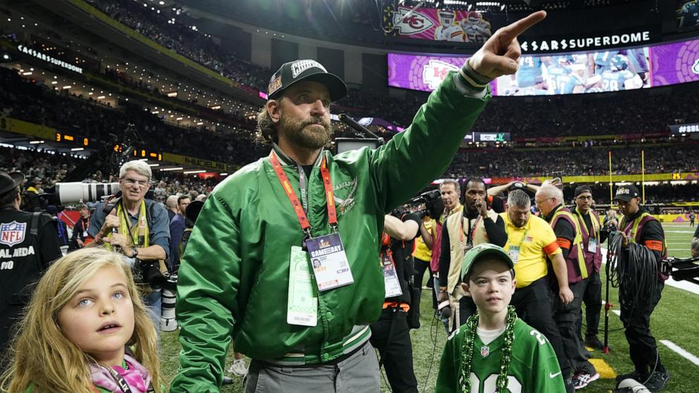 PHOTO: Bradley Cooper walks the sidelines before the start of Super Bowl LIX in New Orleans, Feb. 9, 2025.