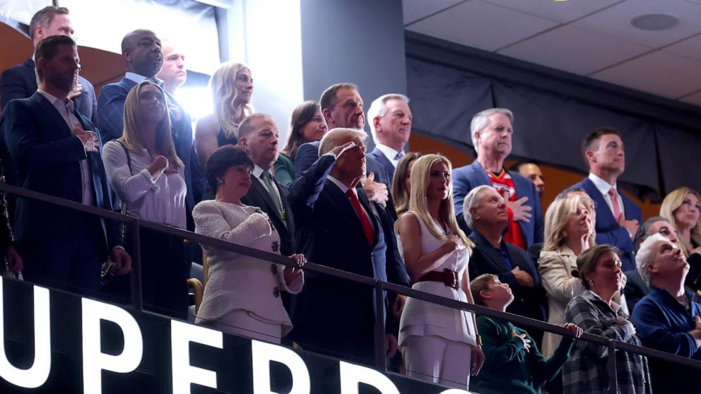 PHOTO: President Donald Trump salutes during the national anthem with Ivanka Trump and New Orleans Saints owner Gayle Benson before the start of Super Bowl LIX in New Orleans, Feb. 9, 2025.