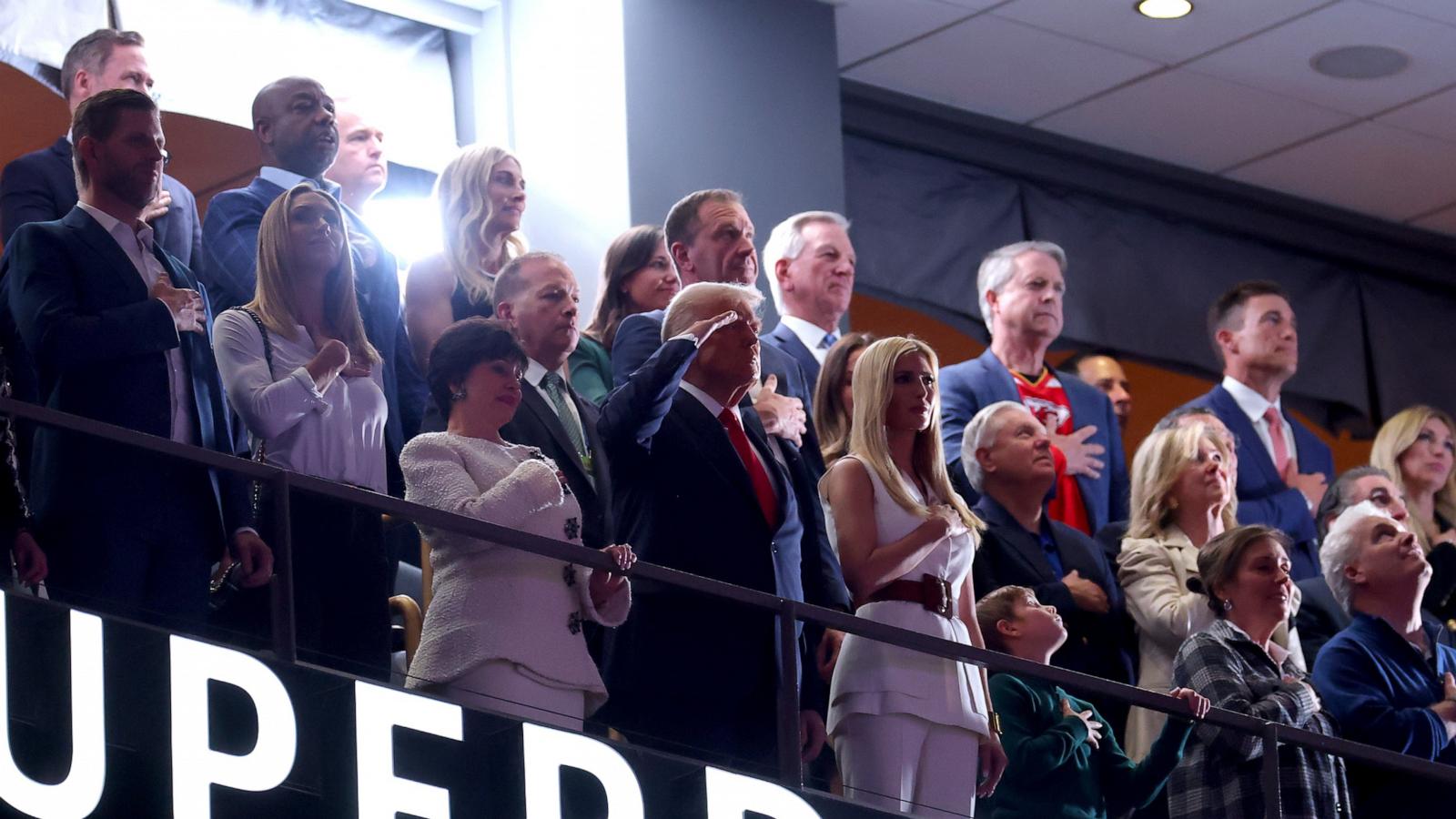 PHOTO: President Donald Trump salutes during the national anthem with Ivanka Trump and New Orleans Saints owner Gayle Benson before the start of Super Bowl LIX in New Orleans, Feb. 9, 2025.