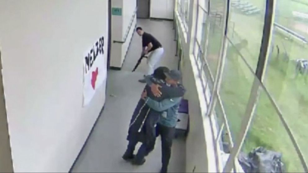 PHOTO: A still from a security video from Parkrose High School shows Keanon Lowe hugging a student who brought a shotgun to school.