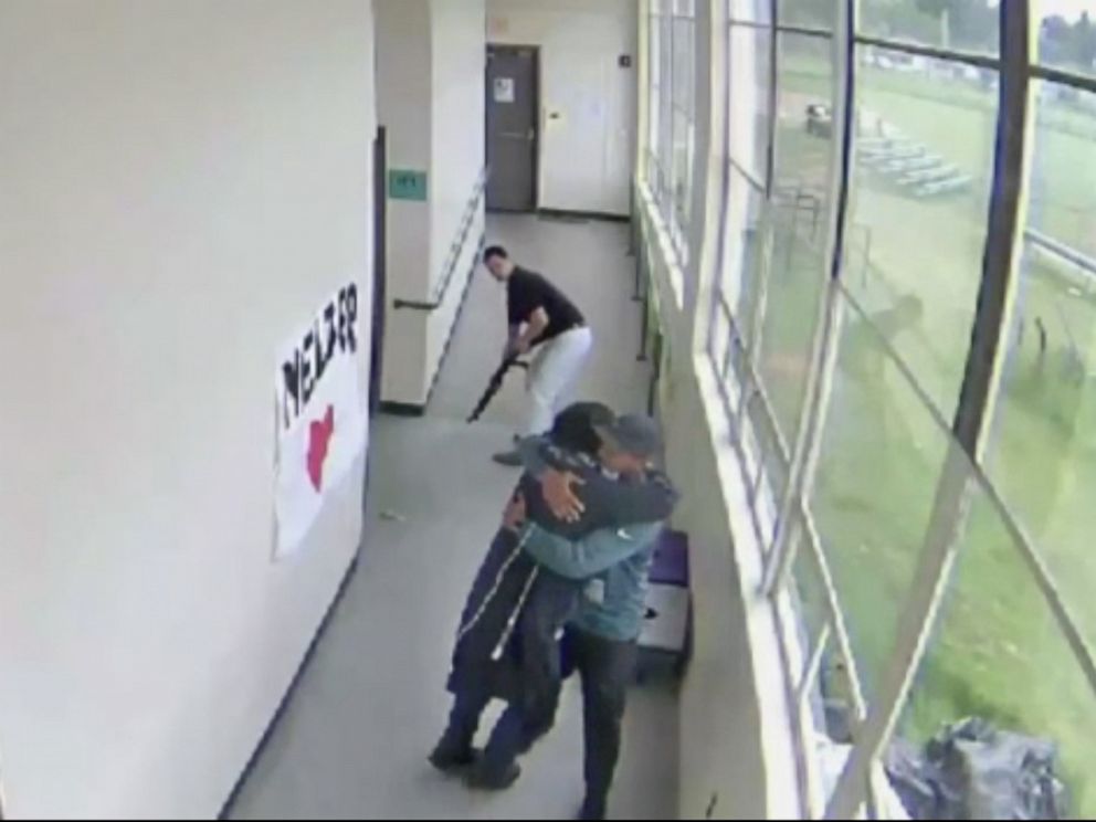 PHOTO: A still from a security video from Parkrose High School shows Keanon Lowe hugging a student who brought a shotgun to school.
