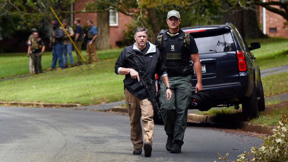 PHOTO: Law enforcement officers search the Foxhall neighborhood behind Mount Tabor High School in Winston-Salem, N.C., after a shooting that left one student dead, Sept. 1, 2021. 