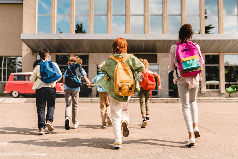 PHOTO: School children walking to the school building.