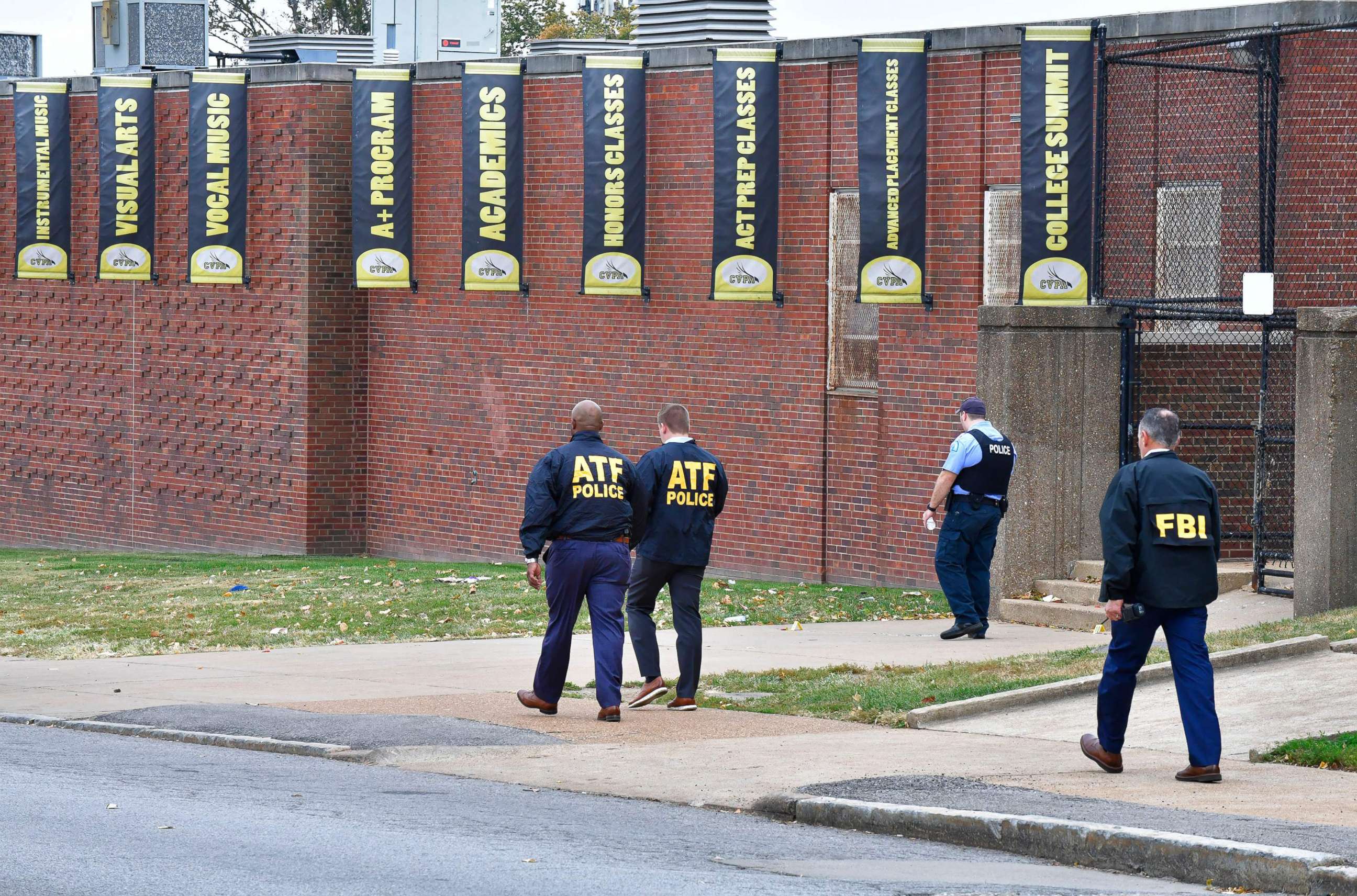 PHOTO: Alcohol, Tobacco, & Firearms agents alongside a FBI agent and a St. Louis metropolitan police officer, walk outside the north side of the Central Visual and Performing Arts High School after a shooting, Oct. 24, 2022, in St. Louis.