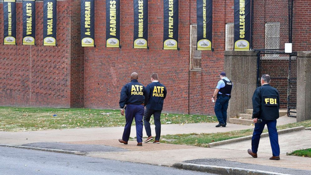 PHOTO: Alcohol, Tobacco and Firearms agents walk with an FBI agent and a St. Louis Metropolitan Police officer outside the north side of Central High School for Fine and Performing Arts after a shooting, Oct. 24, 2022, in St. Louis.  .