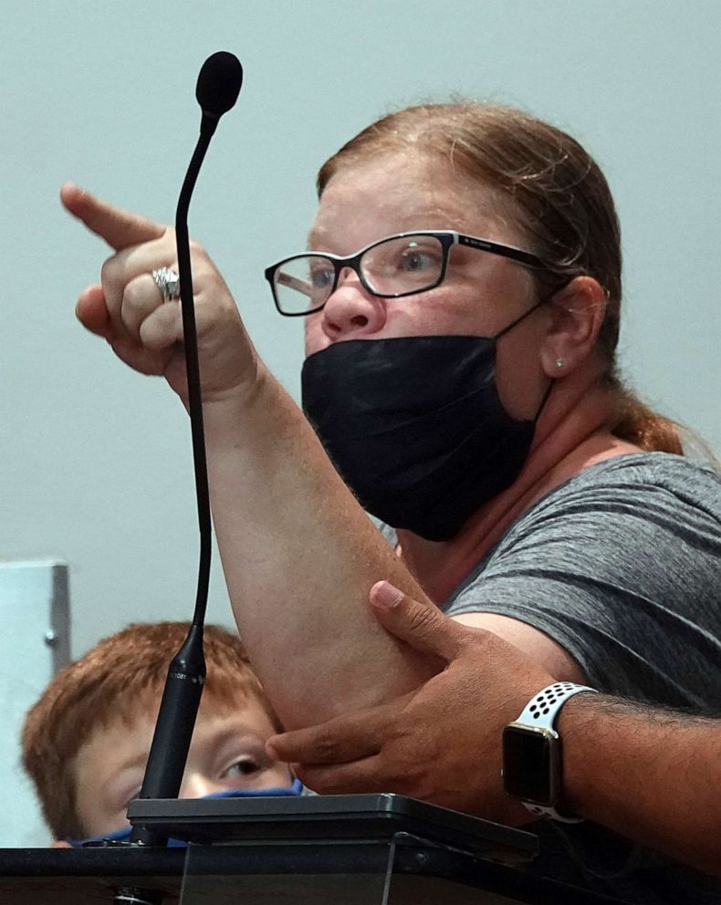 PHOTO: An angry mom reacts as she has her microphone cut off at a Broward School board meeting in Fort Lauderdale, Fla., during a Broward County School Board meeting, Aug. 24, 2021.