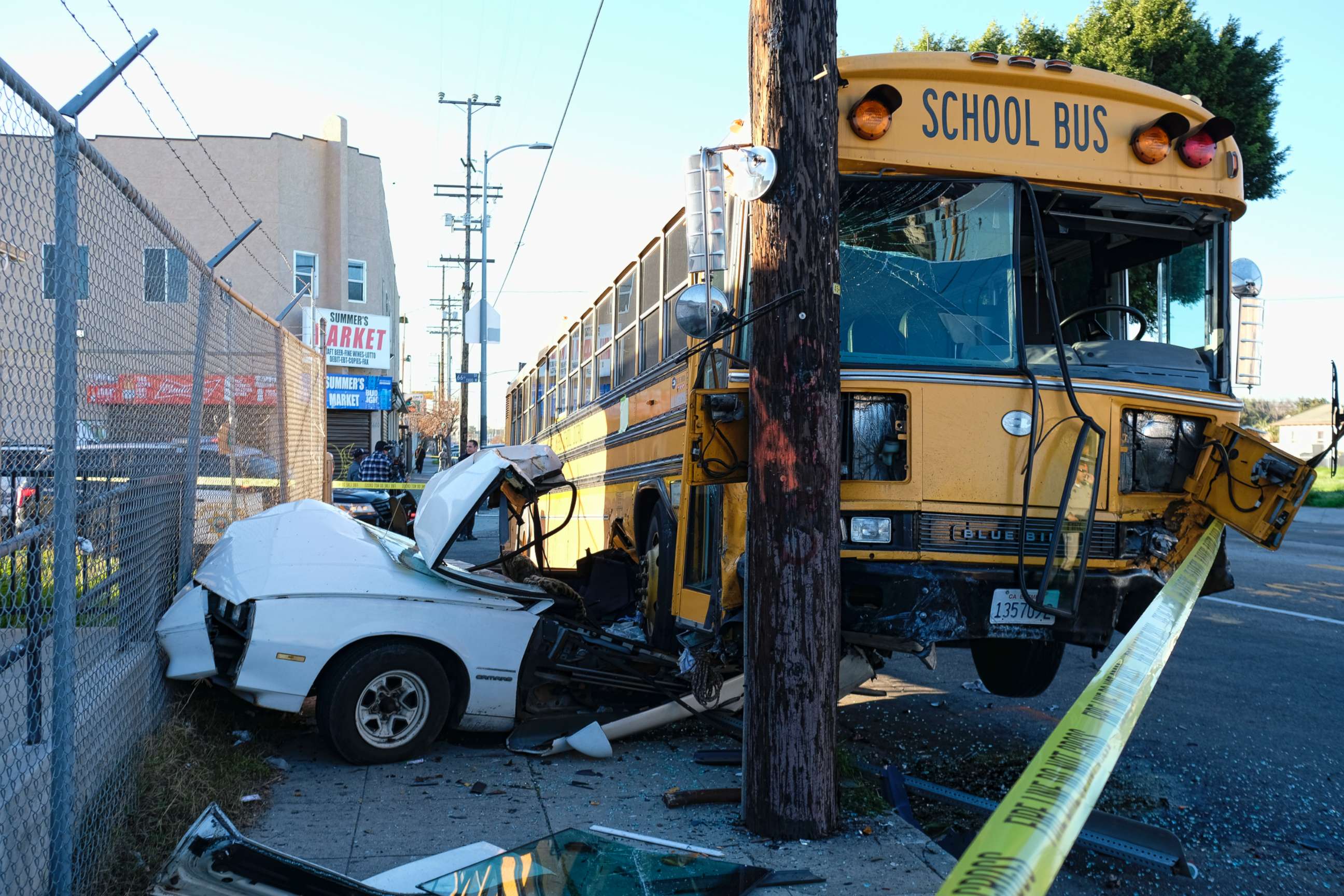 PHOTO: A car is wedged under a school bus that crashed in South Los Angeles on Friday, Jan. 27, 2017.
