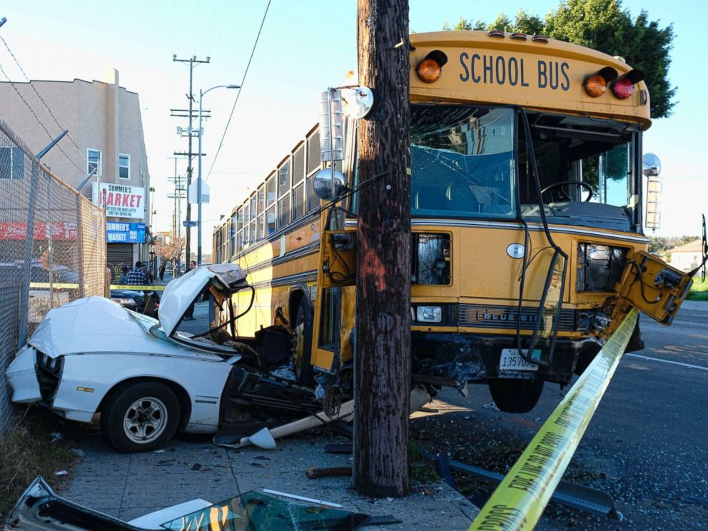 PHOTO: A car is wedged under a school bus that crashed in South Los Angeles on Friday, Jan. 27, 2017.