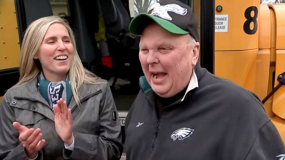 PHOTO: Amy Smith, left, applauding Gary Kelmer, known as Mr. Gary. The Mt. Laurel, NJ school bus driver was given two Super Bowl tickets and airfare to cover the cost of the trip for him and his wife.