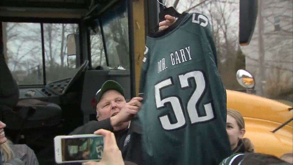 PHOTO: School bus driver Gary Kelmer, better known as Mr. Gary, holds up a Philadelphia Eagles football jersey with his name on it, that was presented to him. 