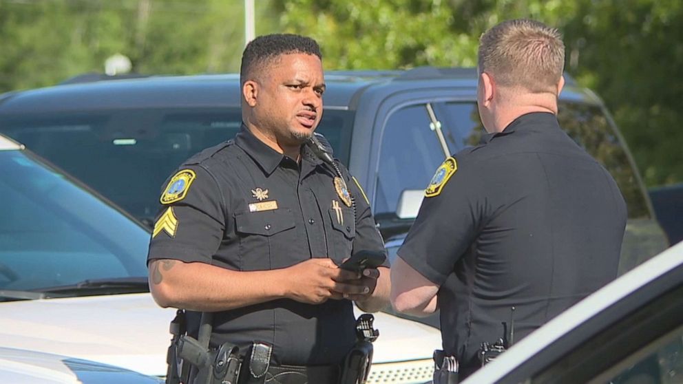 PHOTO: Columbia, S.C. police officers stand near a press conference about an incident where a Fort Jackson trainee hijacked a school bus full of 18 elementary school students in Richland County, S.C., May 6, 2021.