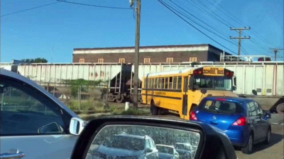 PHOTO: An image made from video appears to show a school bus for the East Baton Rouge Parish schools making an illegal turn near a stopped train.