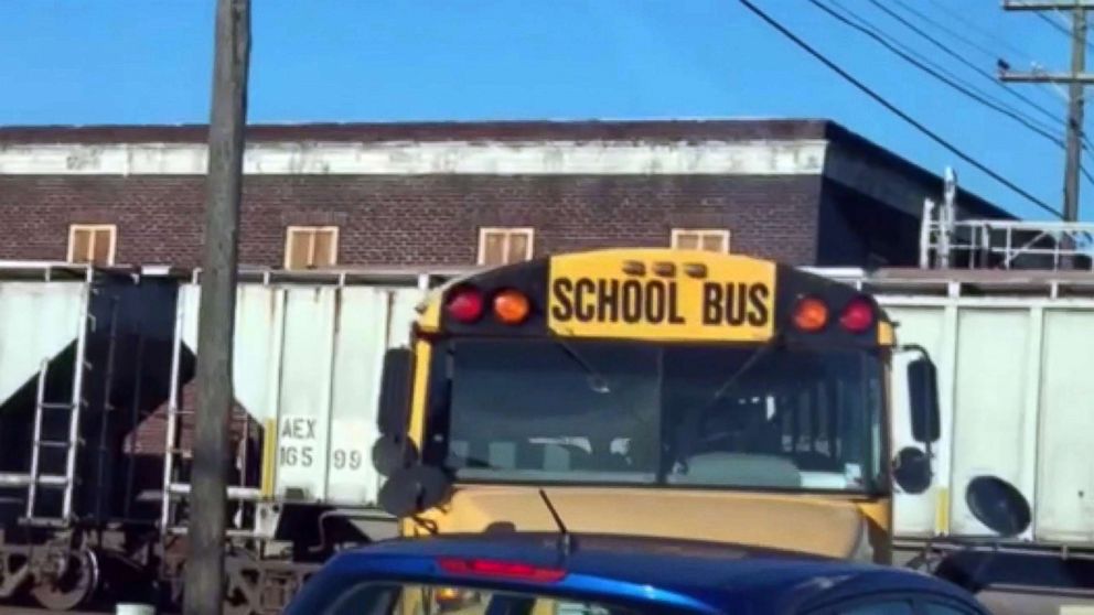 PHOTO: An image made from video appears to show a school bus for the East Baton Rouge Parish schools making an illegal turn near a stopped train.
