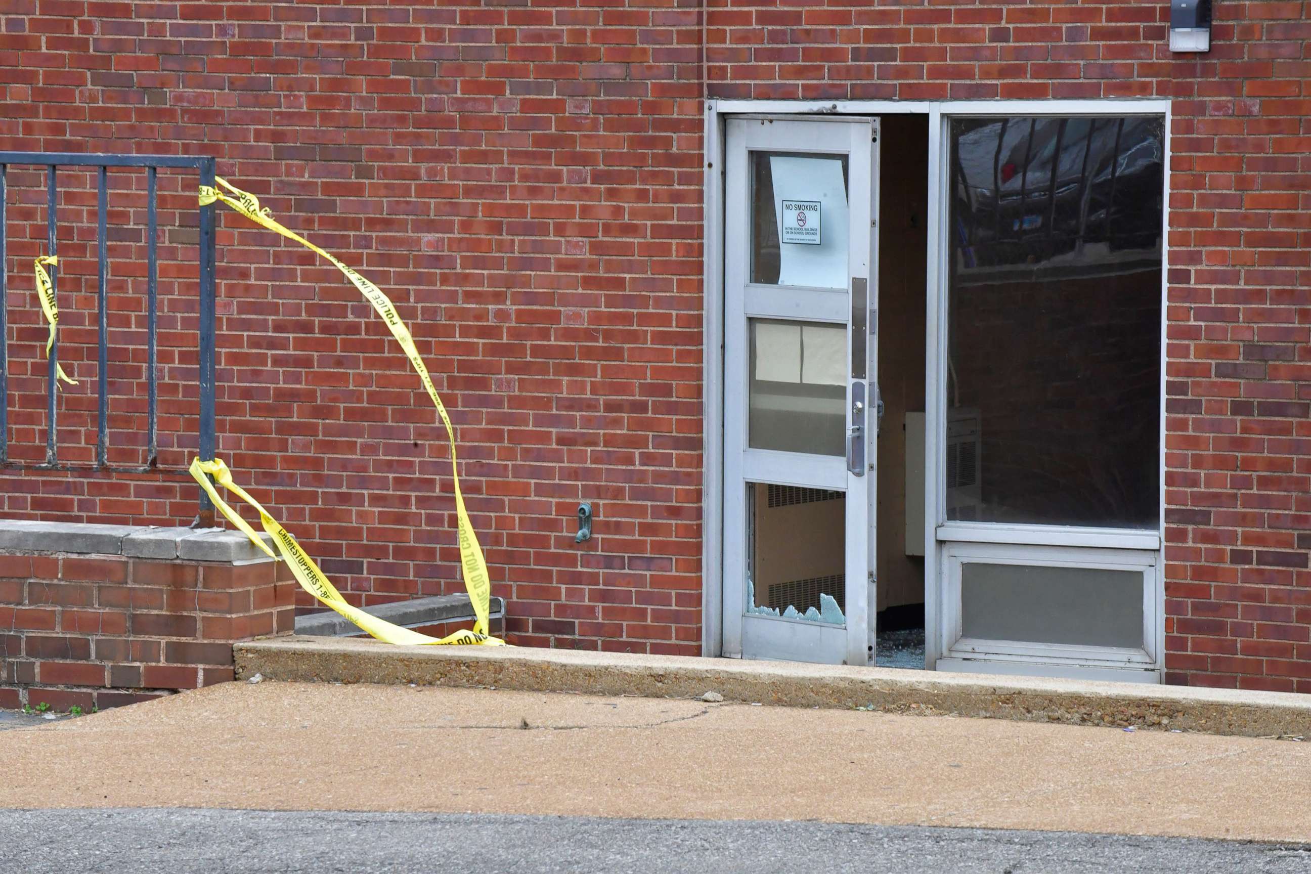 PHOTO: Broken glass at the entrance on the north side of the Central Visual and Performing Arts High School after a shooting in St Louis, Missouri, Oct. 24, 2022.