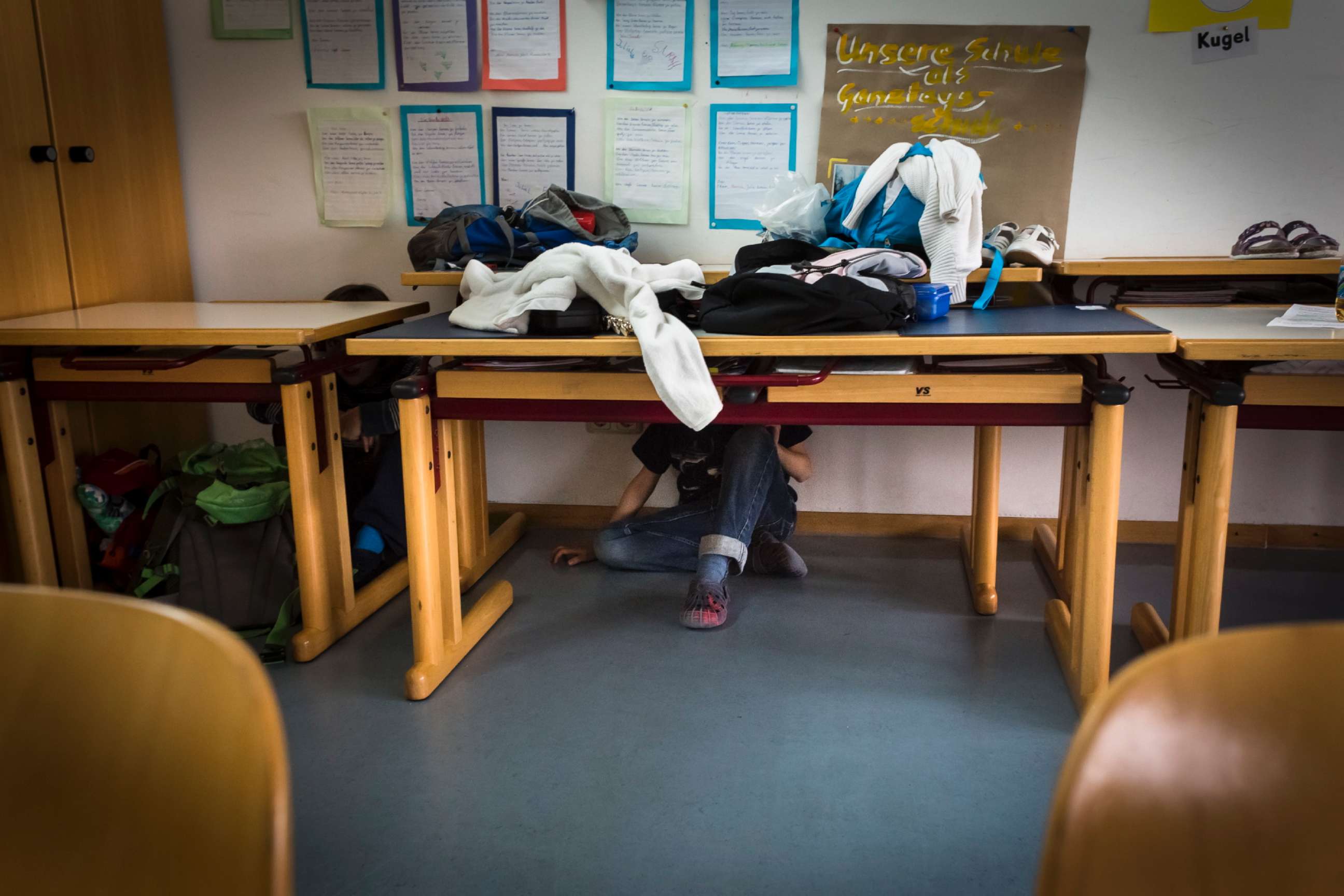 PHOTO: Elementary students cover under their desks during a drill in this undated photo.