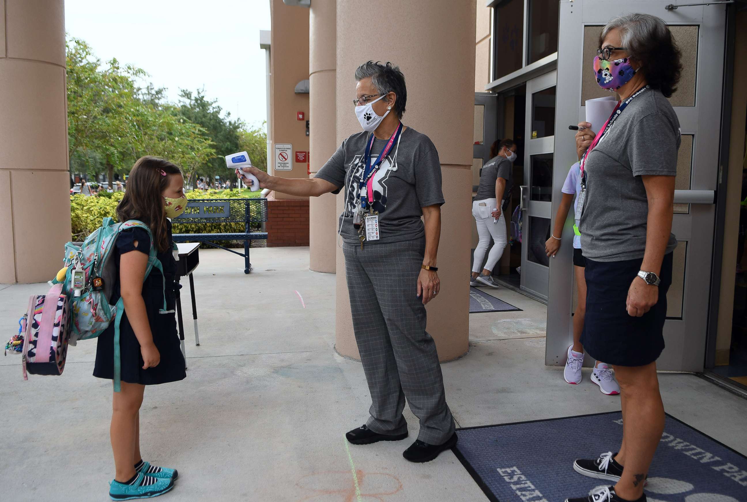 PHOTO: In this Aug. 21, 2020, file photo, a school employee checks the temperature of a student as she returns to school on the first day of in-person classes in Orange County at Baldwin Park Elementary School, in Orlando, Fla.